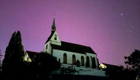 This photo by Dominik Plüss of the St. Chrischona Chuch in Bettingen outside Basel was part of a compilation of Swiss northern light photos last week. Photo: Dominik Plüss